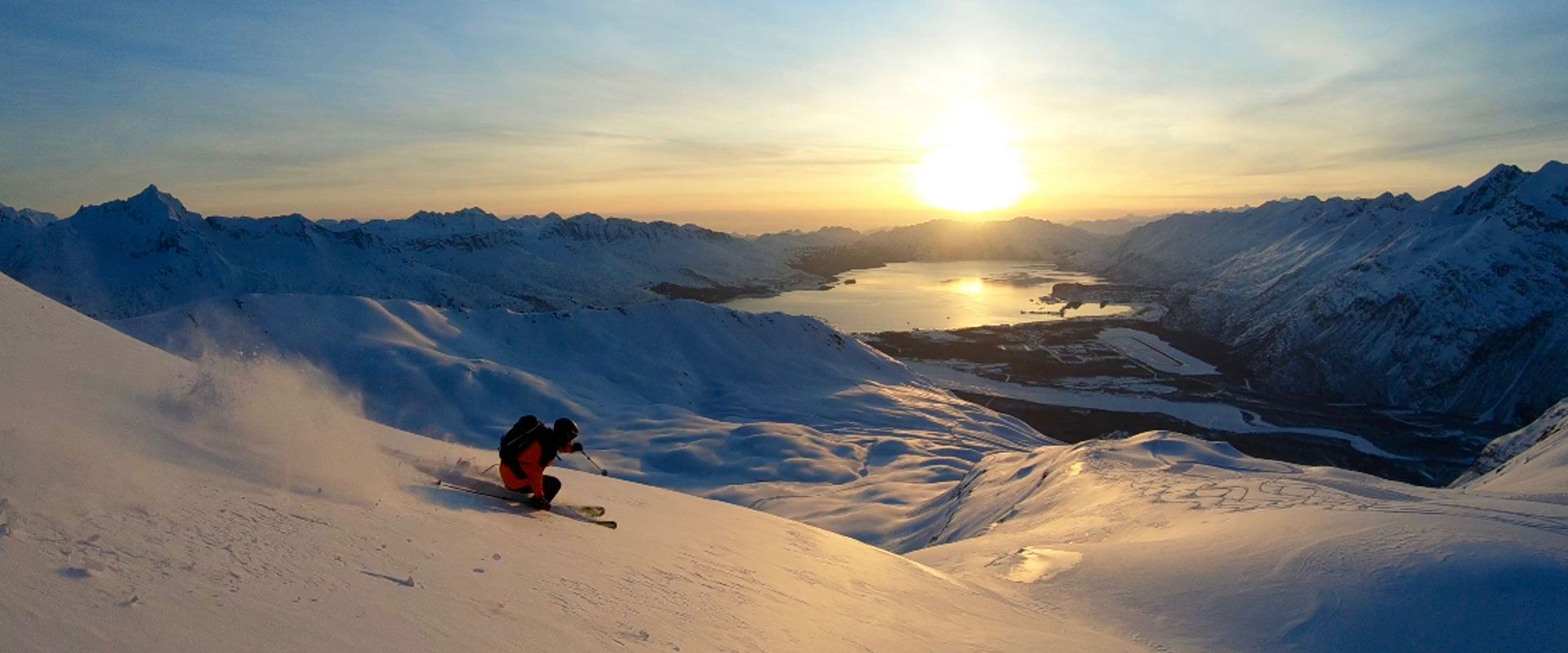Skier on mountain at sunset